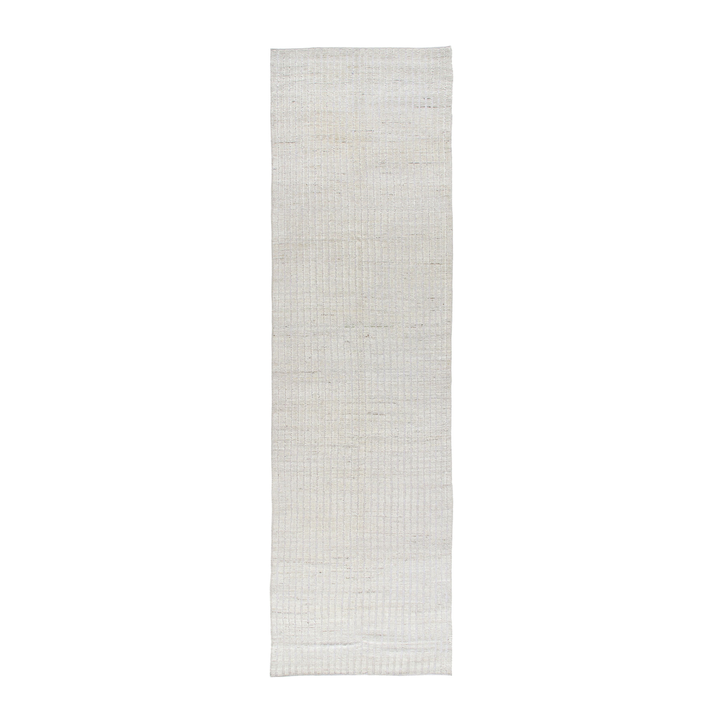 African runner with beige tones that is hand-knotted from naturally dyed wool. 