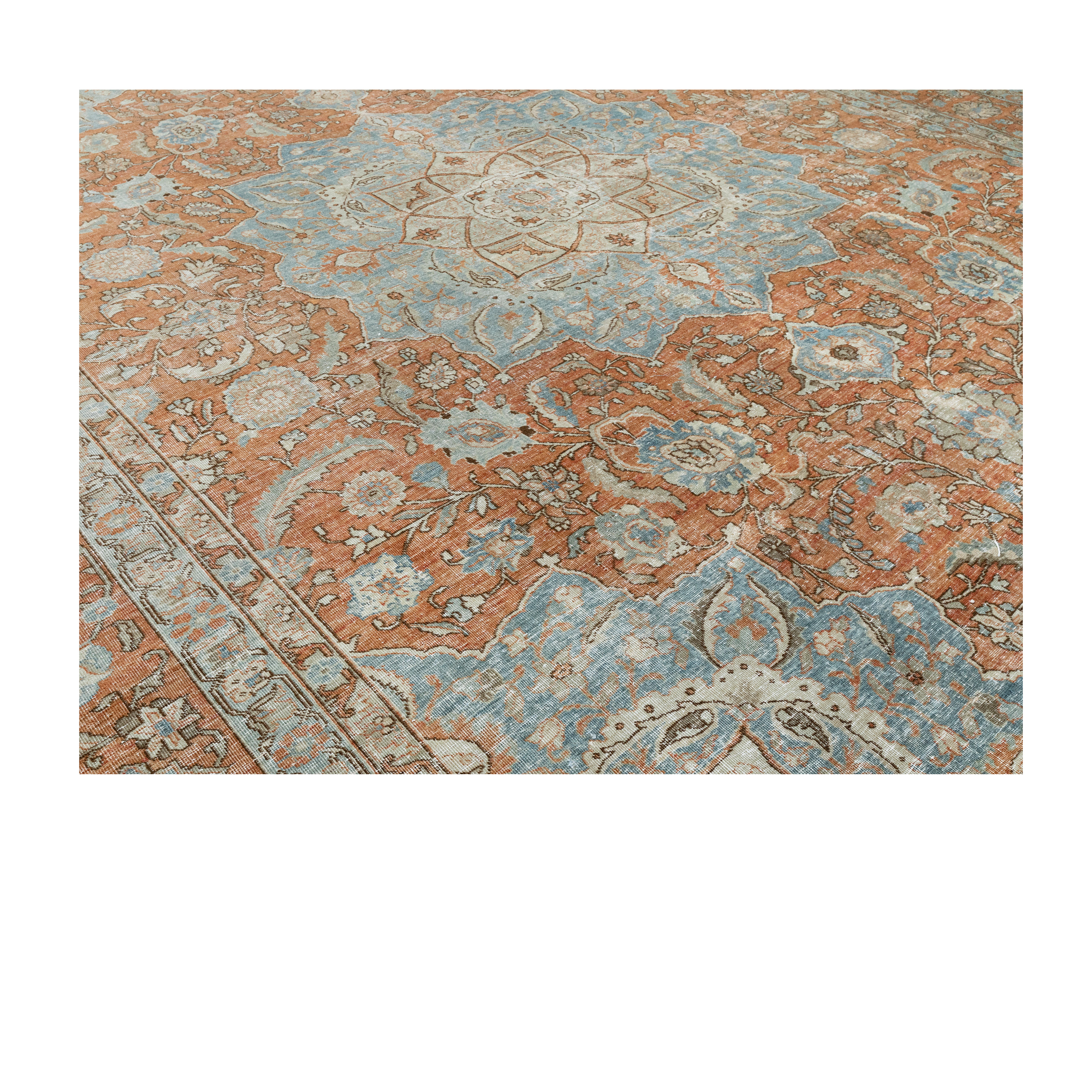 “Vintage Tabriz rug with medallion design in rust and blue tones, hand-knotted in Iran”