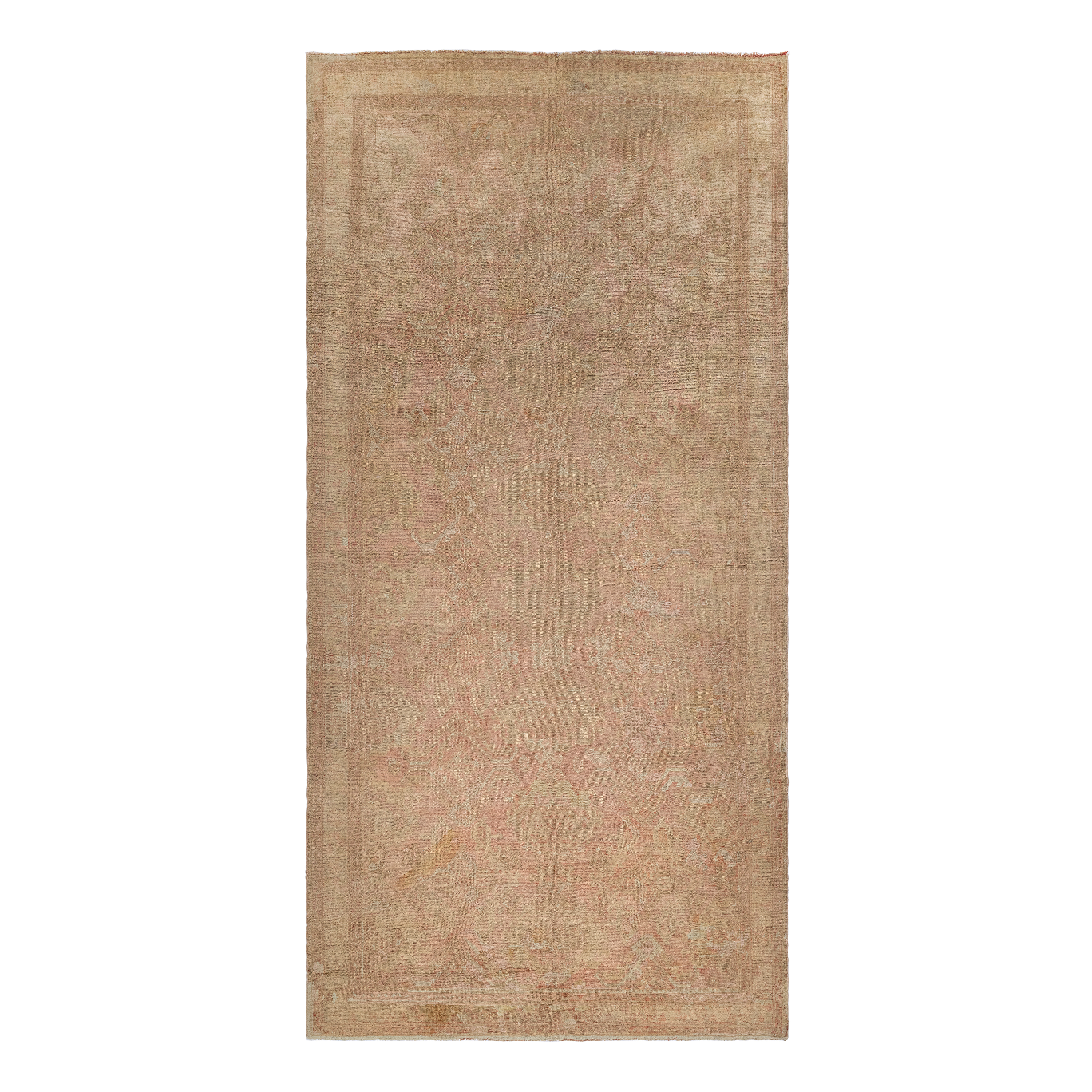 Oushak antique rug in salmon color, handwoven in Turkey with traditional design